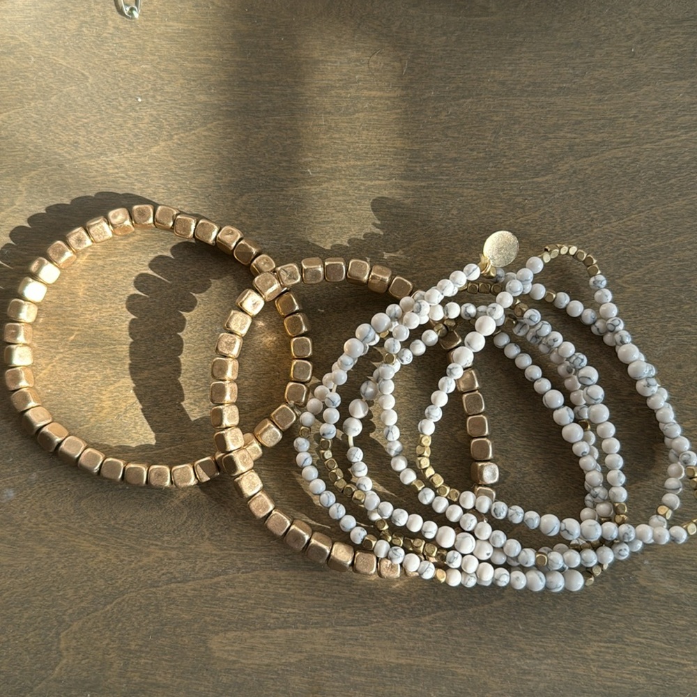 francesca’s white and gold stretchy bangles